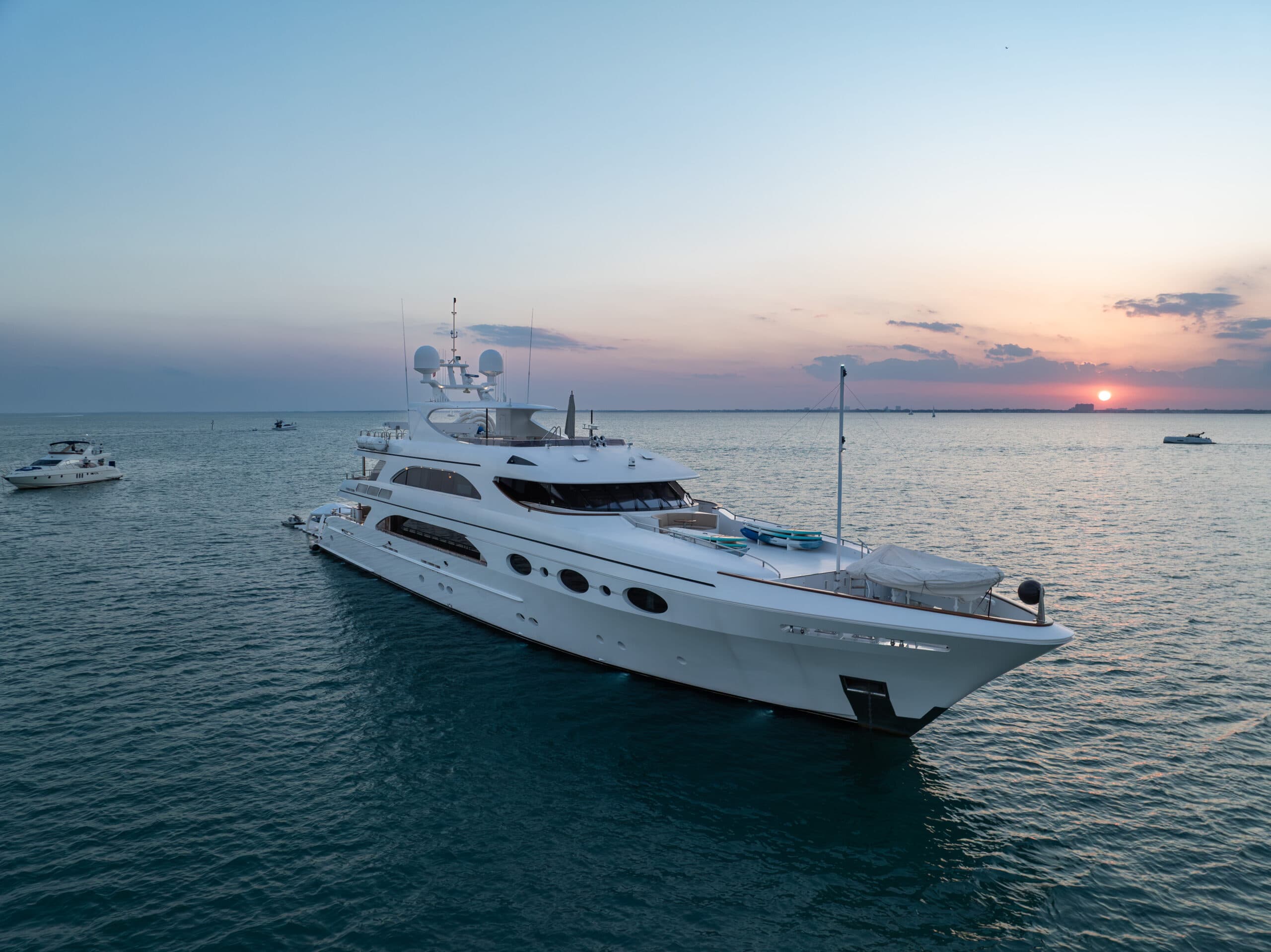 Superyacht charter at night with underwater hull lighting
